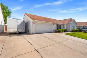 Mediterranean / spanish house featuring a garage, a tile roof, stucco siding, and concrete driveway
