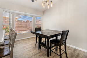 Dining room with plenty of natural light, baseboards, and lofted ceiling