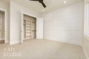 Unfurnished bedroom featuring carpet floors, a decorative wall, recessed lighting, and ceiling fan
