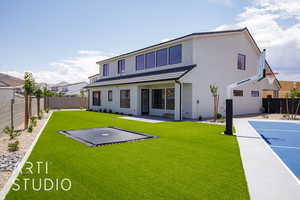 Rear view of house featuring stucco siding