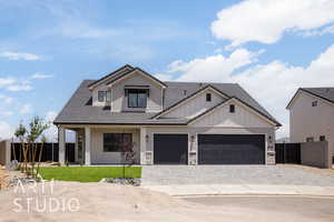 Modern inspired farmhouse with board and batten siding, decorative driveway, an attached garage, a tiled roof, and stone siding