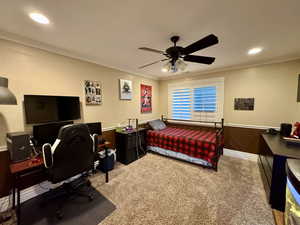 Carpeted bedroom featuring ornamental molding, recessed lighting, a desk, baseboards, and ceiling fan