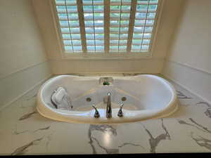 Bathroom with a tub with jets