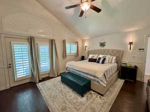Bedroom featuring vaulted ceiling, wood finished floors, ceiling fan, and baseboards
