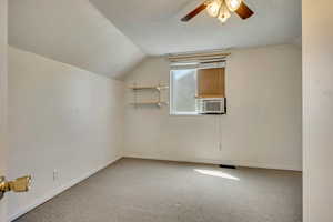 Bonus room featuring vaulted ceiling, ceiling fan, carpet flooring, and baseboards