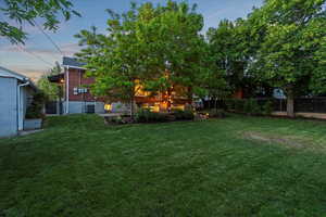 Yard at dusk with central AC unit
