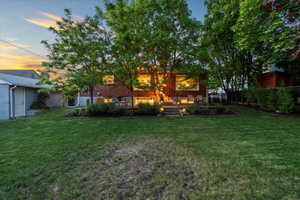 Back of house featuring a lawn