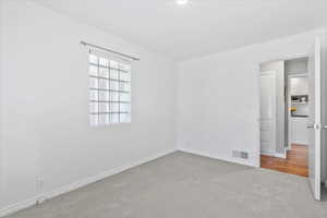 Empty room with carpet and baseboards