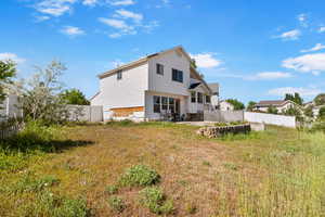 Back of house with a fenced backyard