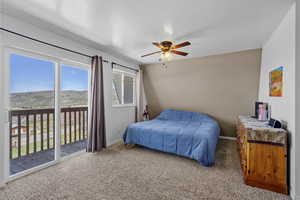Bedroom with carpet, baseboards, and access to outside