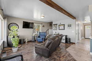 Living area featuring wood finished floors, healthy amount of natural light, and baseboards