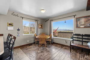 Dining room featuring baseboards, wood finished floors, and a mountain view