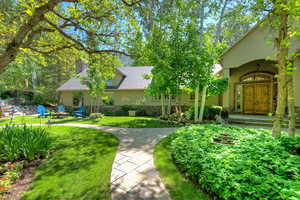 View of green lawn featuring a fire pit