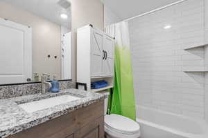 Full bath featuring toilet, shower / tub combo, and vanity