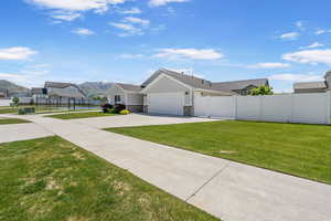 View of front of home featuring a gate, driveway, an attached garage, stone siding, and a mountain view