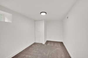 Basement featuring carpet and baseboards