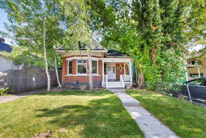 View of front of house featuring brick siding and covered porch