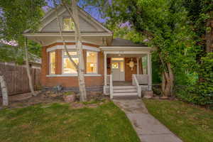 View of front of home with brick siding and a porch