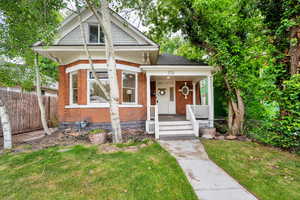 View of front of house featuring brick siding and covered porch