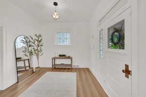 Entrance foyer featuring light wood finished floors and baseboards