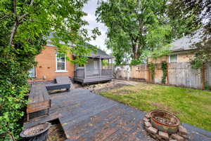 View of yard featuring a fire pit and a wooden deck