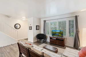 Living area with wood finished floors and baseboards