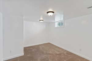 Basement featuring carpet floors and baseboards