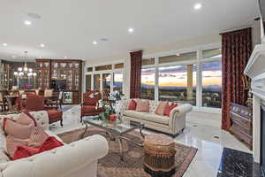 Living area with a chandelier, recessed lighting, and light tile patterned floors
