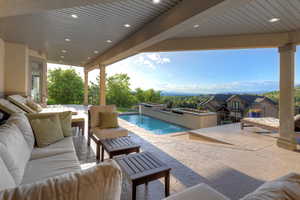 Swimming pool with an outdoor hangout area and a patio