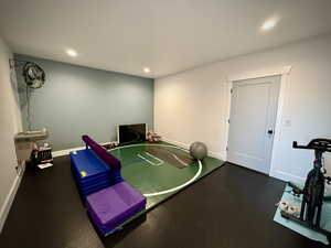 Game room featuring baseboards, recessed lighting, and rubber floors