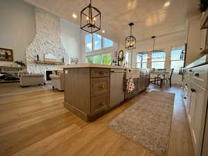 Kitchen with a chandelier, healthy amount of natural light, open floor plan, light wood-style flooring, and recessed lighting