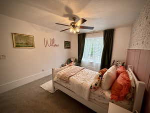 Bedroom featuring carpet flooring, a textured ceiling, and a ceiling fan
