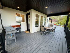 Wooden deck featuring outdoor dining area