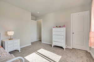Carpeted bedroom featuring baseboards