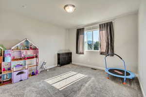 Game room featuring carpet flooring and baseboards