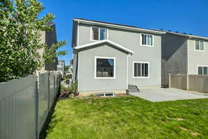Back of house with stucco siding and a patio area