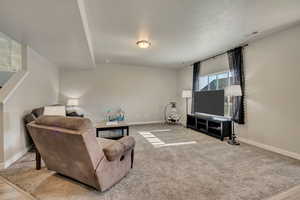 Living area featuring baseboards and carpet flooring