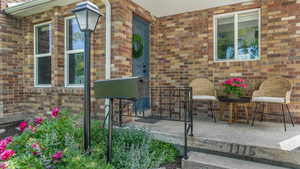 Entrance to property with brick siding