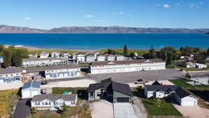 Aerial perspective of suburban area with a water and mountain view