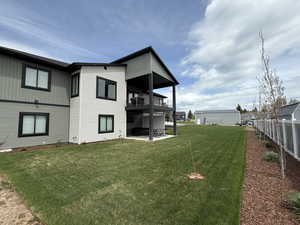 View of yard featuring a balcony and a patio area