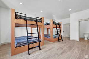 Unfurnished bedroom featuring wood finished floors, recessed lighting, and baseboards