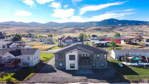 Aerial perspective of suburban area with a mountainous background