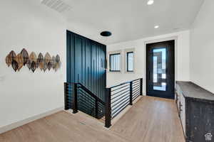 Entryway with light wood-style floors, recessed lighting, and baseboards