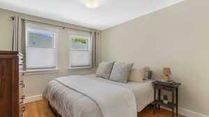 Bedroom featuring baseboards and wood finished floors
