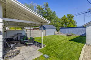 View of yard with a patio and an outdoor structure
