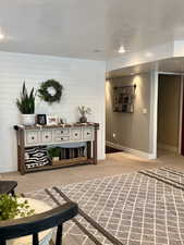 Sitting room with carpet floors and baseboards