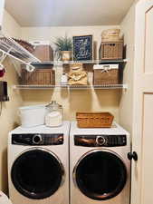Clothes washing area featuring independent washer and dryer