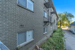 View of backside of property with brick siding