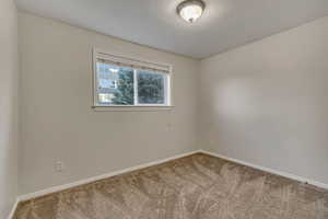 Bedroom  featuring carpet flooring and baseboards