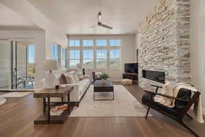 Living room featuring a ceiling fan, healthy amount of natural light, and wood finished floors